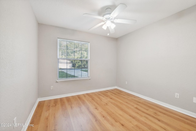 unfurnished room with ceiling fan and wood-type flooring