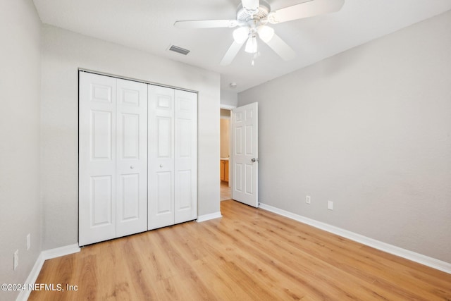 unfurnished bedroom featuring a closet, ceiling fan, and light wood-type flooring