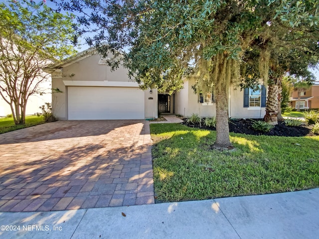 view of front facade with a garage and a front yard