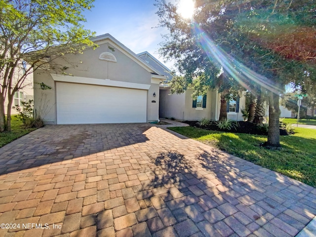 view of front of house featuring a front yard and a garage