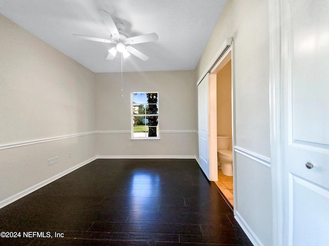 unfurnished room featuring dark hardwood / wood-style floors and ceiling fan