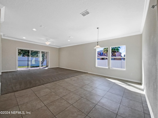 tiled spare room with ceiling fan and ornamental molding