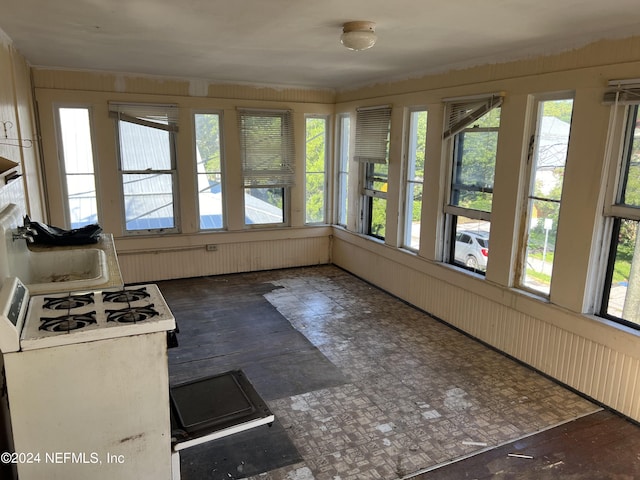 unfurnished sunroom featuring sink and plenty of natural light