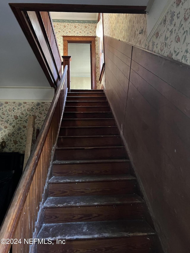 stairs featuring wood-type flooring