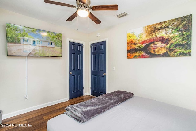 bedroom featuring dark hardwood / wood-style floors and ceiling fan