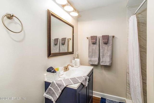 bathroom with a shower with curtain and vanity