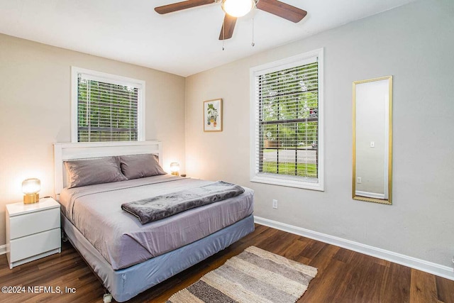 bedroom with dark hardwood / wood-style floors and ceiling fan