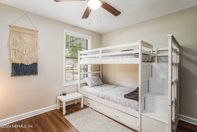 bedroom with dark hardwood / wood-style flooring and ceiling fan