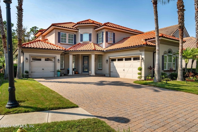 mediterranean / spanish-style home with a front lawn