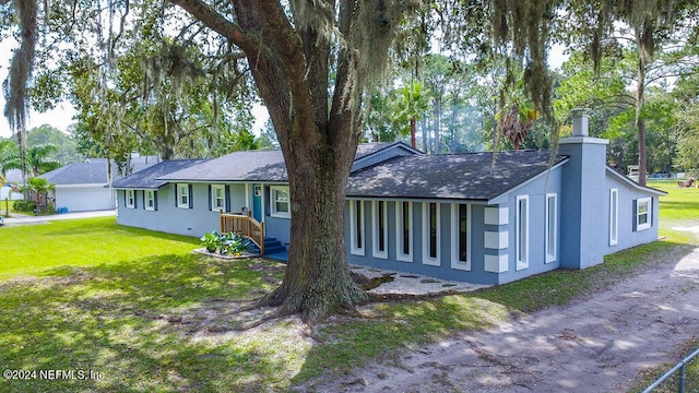 rear view of property featuring a yard