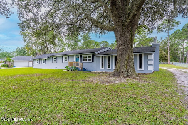 ranch-style house with a front lawn