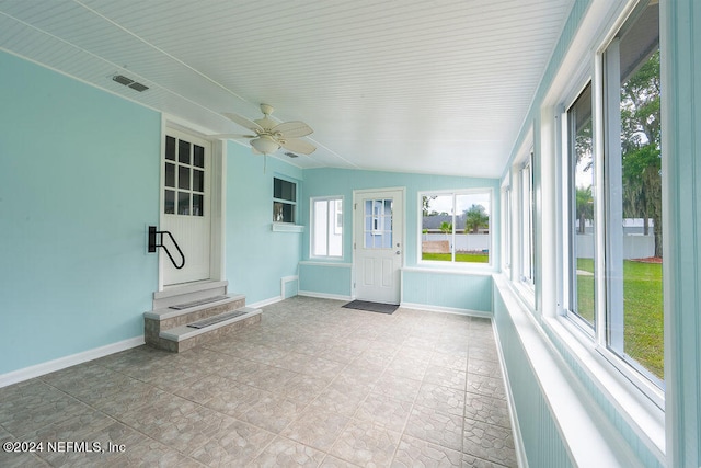 unfurnished sunroom featuring lofted ceiling and ceiling fan