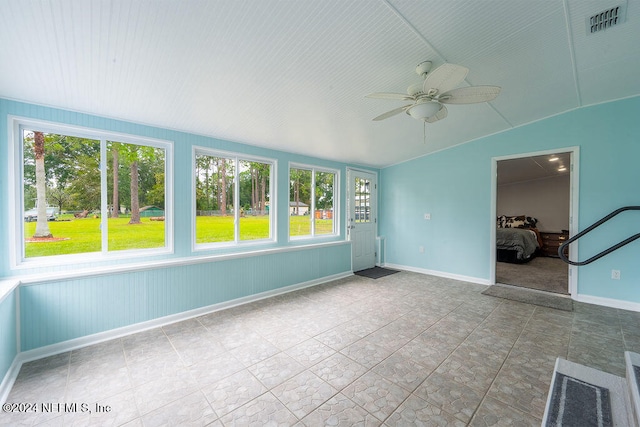 unfurnished sunroom with ceiling fan and lofted ceiling