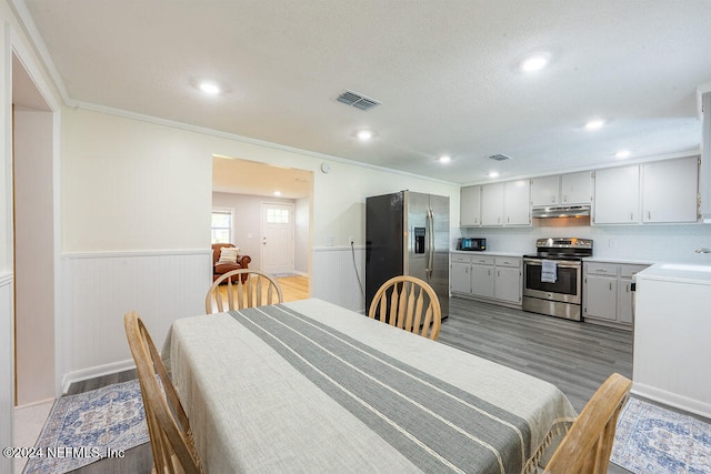 dining area with crown molding and dark hardwood / wood-style floors