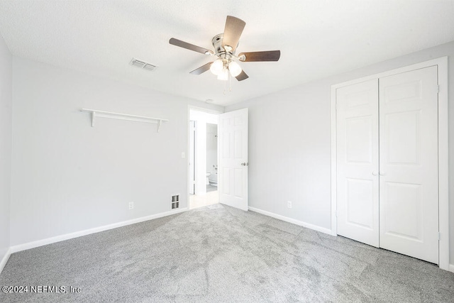 unfurnished bedroom with ceiling fan, a closet, and carpet flooring