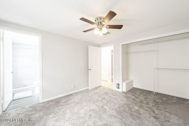 unfurnished bedroom featuring ceiling fan, a closet, ensuite bath, and carpet flooring