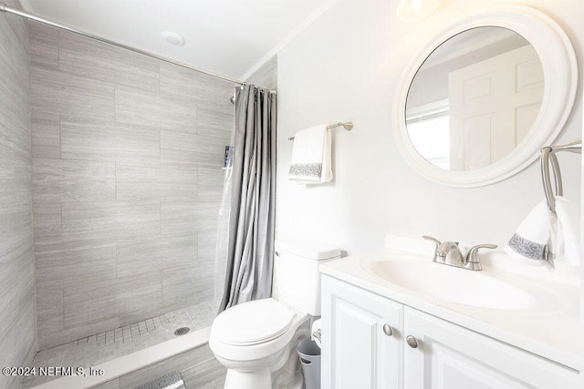 bathroom with ornamental molding, vanity, toilet, and curtained shower