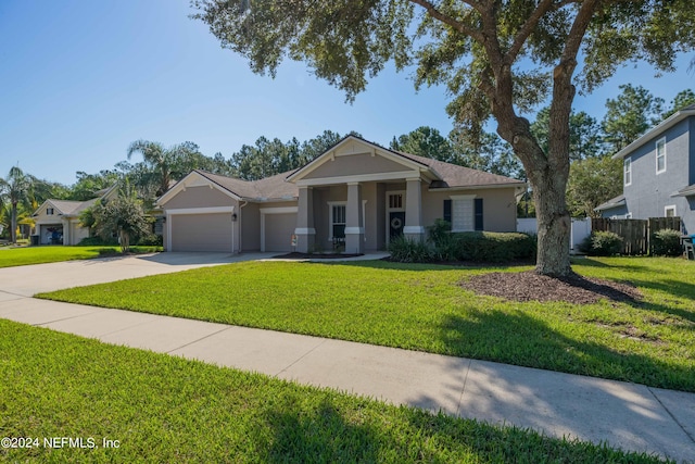 view of front facade with a front yard and a garage