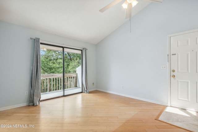 empty room with ceiling fan, light hardwood / wood-style floors, and high vaulted ceiling