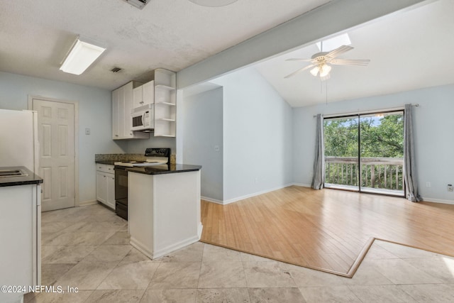2696 Forest Ridge Dr Unit A-6, Fernandina Beach, FL 32034 - kitchen featuring white appliances, open shelves, dark countertops, white cabinetry, and vaulted ceiling