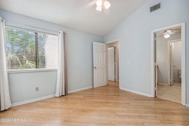 2696 Forest Ridge Dr Unit A-6, Fernandina Beach, FL 32034 - unfurnished bedroom with light wood-style floors, lofted ceiling, connected bathroom, and ceiling fan