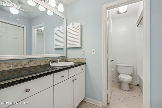 bathroom with decorative backsplash, vanity, toilet, and tile patterned floors