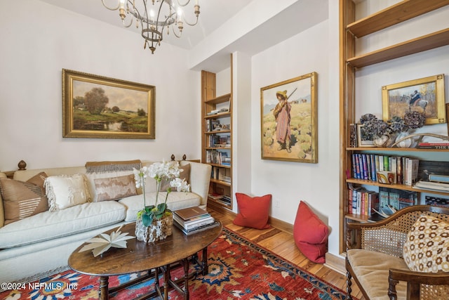 living room featuring wood-type flooring and a notable chandelier