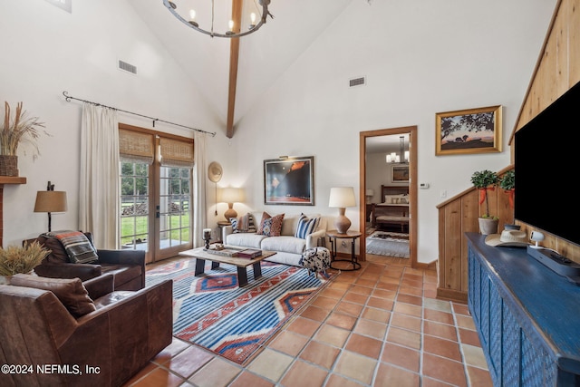 tiled living room with high vaulted ceiling, french doors, and a chandelier