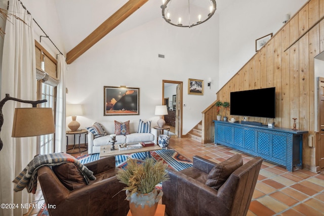 living room featuring light tile patterned flooring, high vaulted ceiling, beam ceiling, and wooden walls