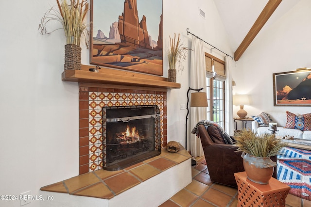 tiled living room with lofted ceiling and a tiled fireplace