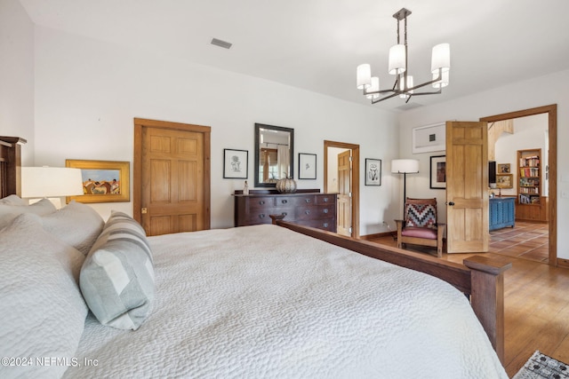 bedroom featuring hardwood / wood-style flooring and a chandelier