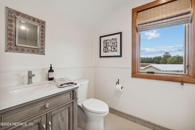 bathroom featuring tile patterned floors, vanity, and toilet