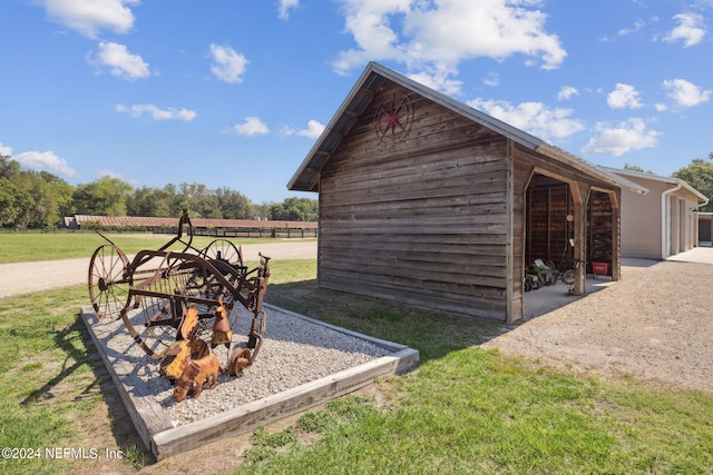 view of outdoor structure with a yard and a rural view