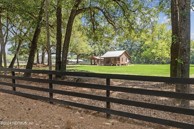 view of gate with a lawn