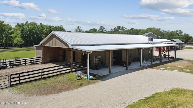 view of horse barn featuring a rural view