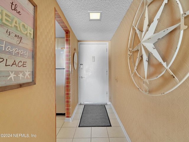 doorway featuring a textured ceiling and tile patterned flooring