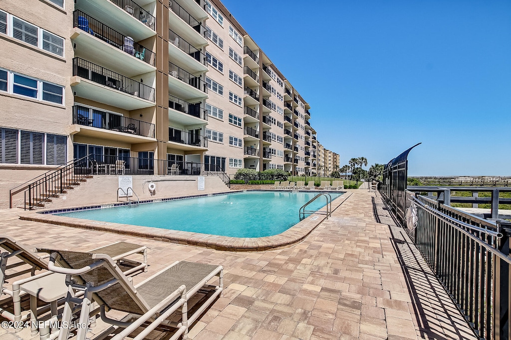 view of swimming pool with a patio