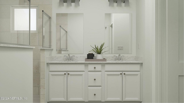 bathroom featuring vanity and a shower with shower door