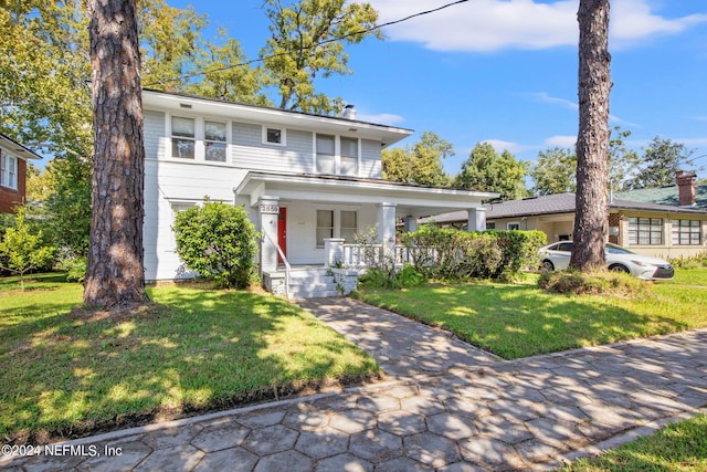 view of front of home featuring a front yard and covered porch