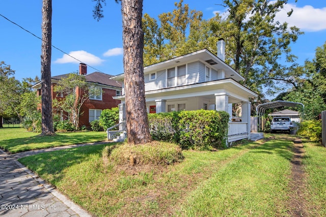 2859 Lydia St, Jacksonville, FL 32205 - american foursquare style home with a chimney, driveway, a detached carport, and a front lawn