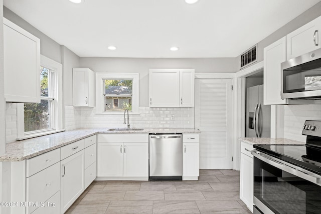 2859 Lydia St, Jacksonville, FL 32205 - kitchen with a sink, stainless steel appliances, plenty of natural light, visible vents, and white cabinets