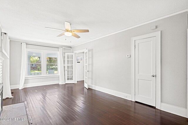 unfurnished living room featuring ceiling fan, french doors, crown molding, and dark hardwood / wood-style flooring