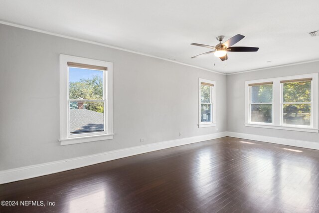 unfurnished room with a healthy amount of sunlight, crown molding, dark wood-type flooring, and ceiling fan