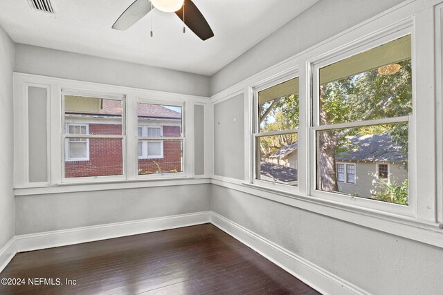 spare room with hardwood / wood-style floors and ceiling fan