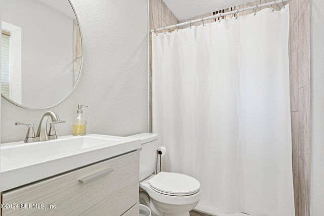 bathroom featuring vanity, toilet, and a shower with curtain