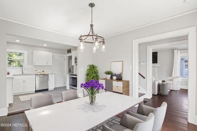 dining space featuring dark hardwood / wood-style flooring, sink, and a notable chandelier