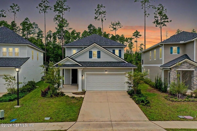 view of front of home featuring a lawn and a garage