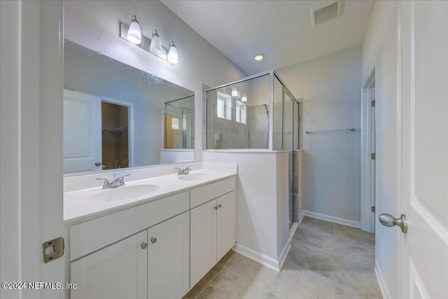 bathroom featuring vanity, tile patterned floors, and an enclosed shower