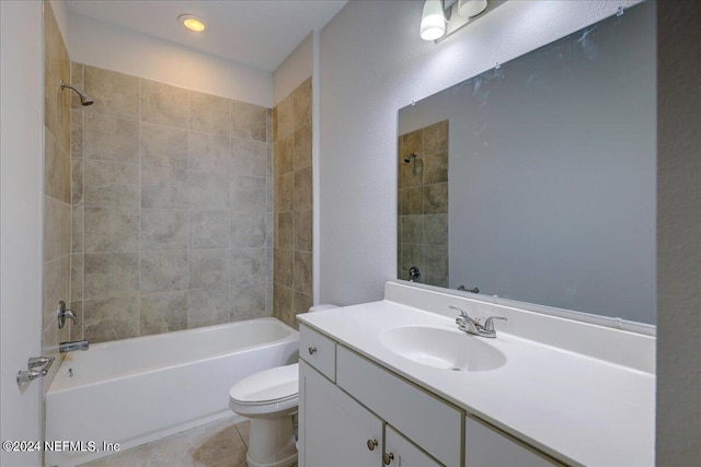 full bathroom with tiled shower / bath, vanity, tile patterned flooring, and toilet