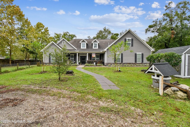 view of front of house with a porch, a shed, and a front yard